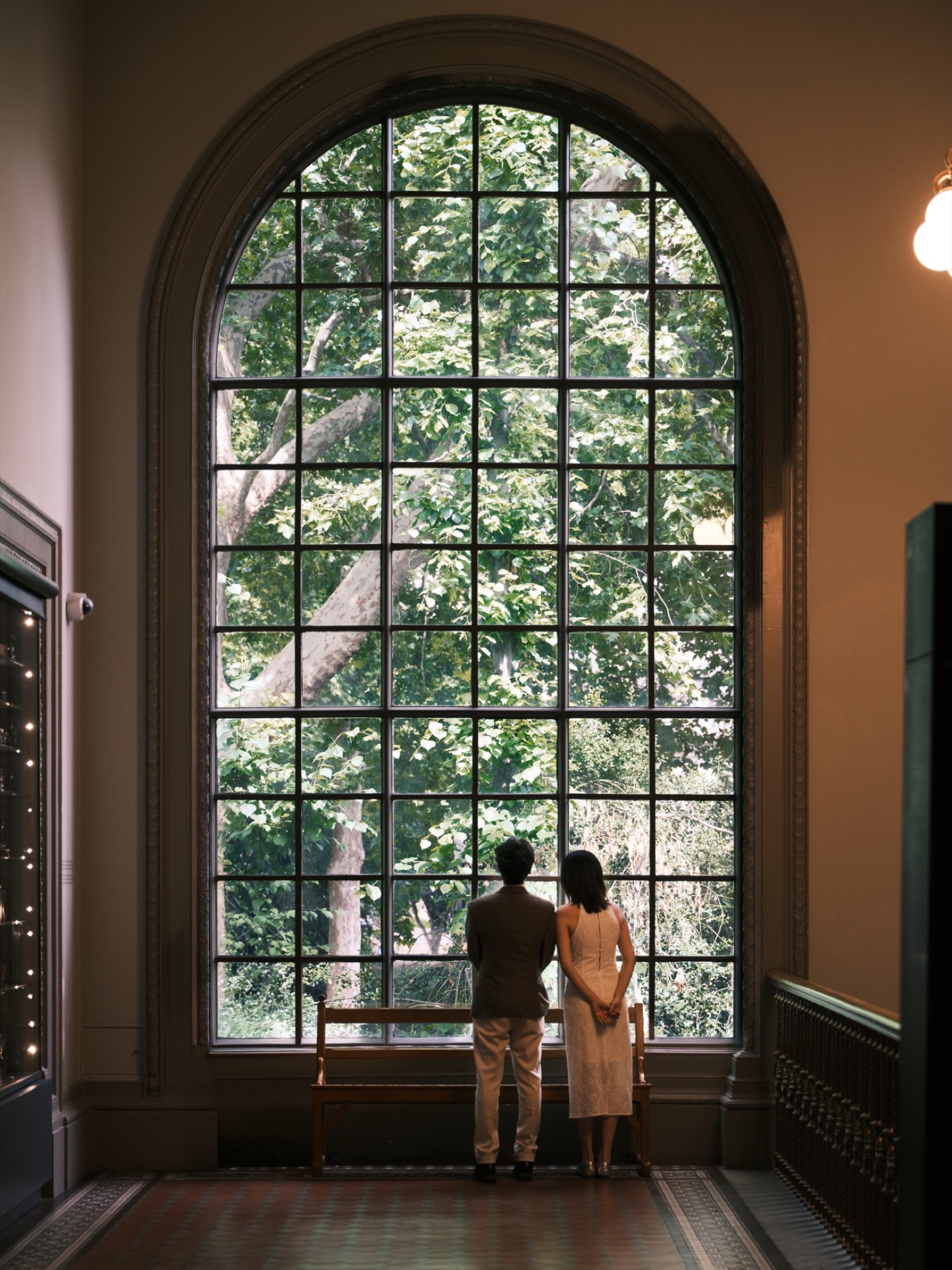 A couple silhouetted by an English window